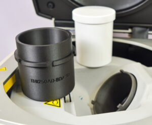 THINKY adapter and container sitting on a THINKY mixing and degassing machine